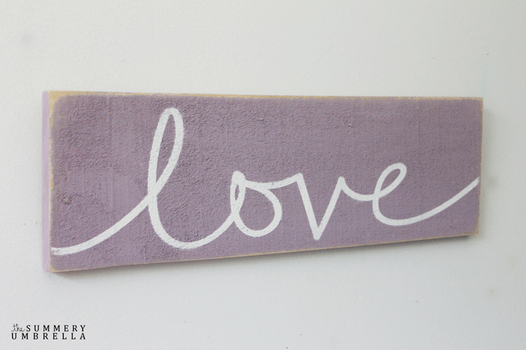 Purple wood sign with the word Love
