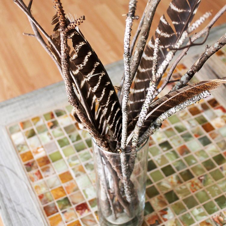 An easy DIY branch centerpiece is all you need to bring a little nature into your home. Check out a few of my favorites now! #centerpiece #naturaldecor #thesummeryumbrella