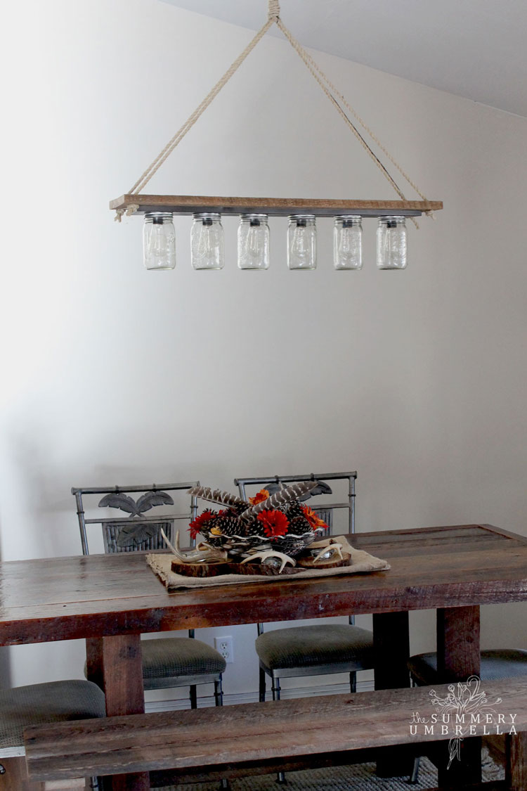 Are you looking for an interesting and unique DIY hanging ceiling light fixture for your kitchen or dining room? Maybe even with a rustic farmhouse and eclectic twist? Then I definitely think you'll love this easy mason jar pendant light! #lightfixtures #farmhouse #thesummeryumbrella