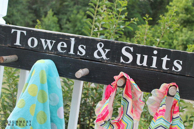 how to make a wood sign that hangs up towels and bathing suits. This one says "Towels and Suits." towel sign for pool