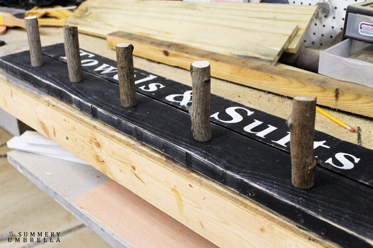 outdoor diy wood sign - use branches as hangers for the bathing suites. 