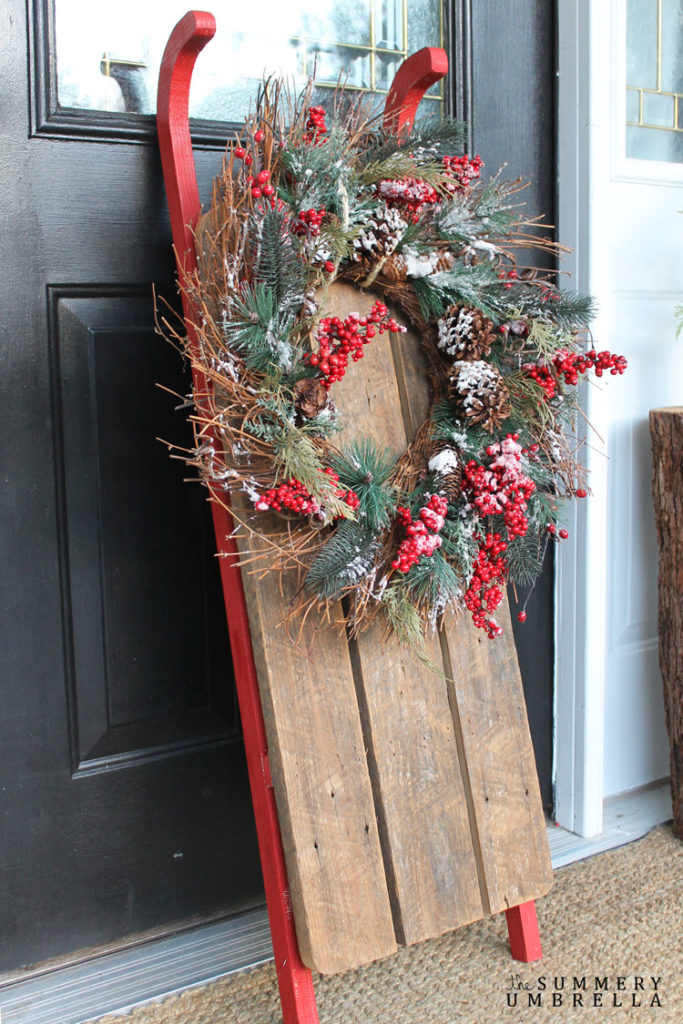 Adorning sled with holiday greenery.