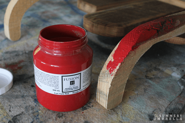 Painting the vintage sled's classic red hue.