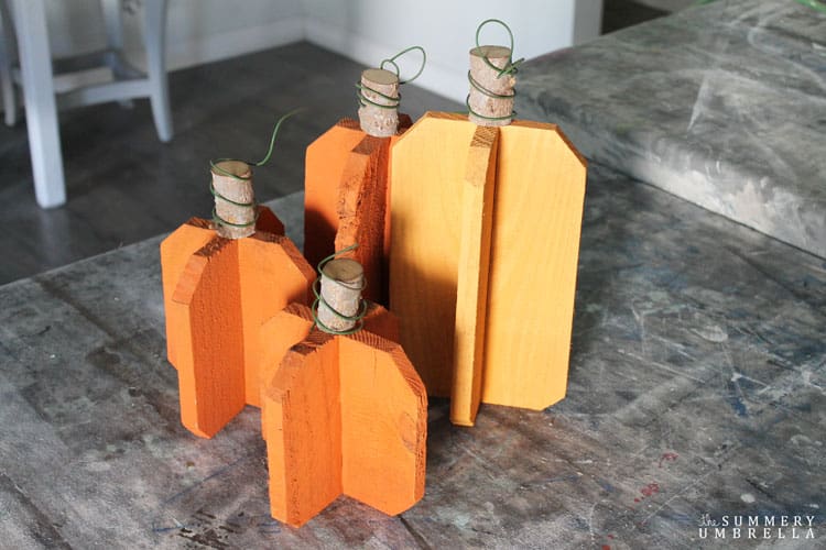 All you need is a few scraps of wood, a branch, wire, and paint to create these super versatile DIY reclaimed wood pumpkins in gray. So easy and pretty too!