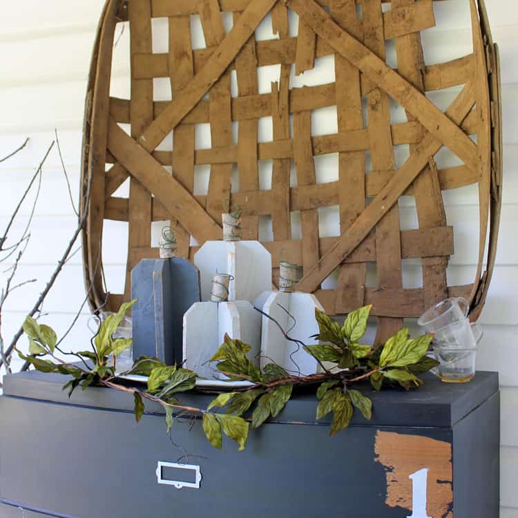 All you need is a few scraps of wood, a branch, wire, and paint to create these super versatile DIY reclaimed wood pumpkins in gray. So easy and pretty too!