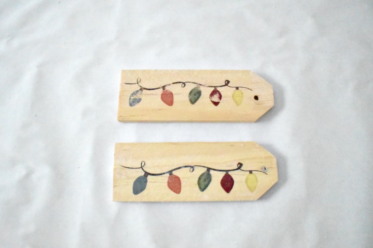 Easily personalize a Christmas gift with a creative DIY gift tag.  There are a lot of gift tag ideas to choose from, but these handmade wooden gift tags are super easy and cute, and can double as ornaments for next Christmas! #gifttags #christmas #thesummeryumbrella