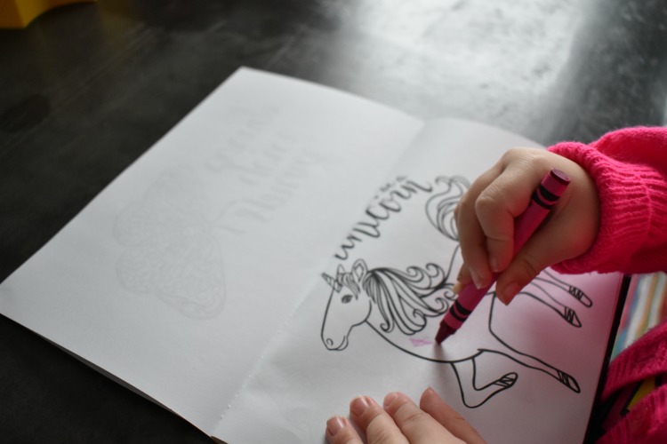 kids coloring on DIY coloring book with unicorn