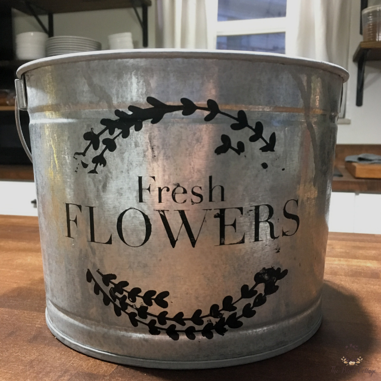 flower market sign stenciled on a galvanized bucket