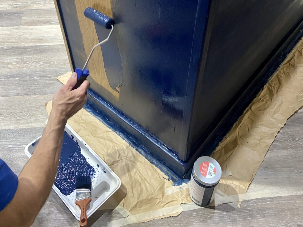 A kitchen island being painted with a fresh coat of chalk-style paint