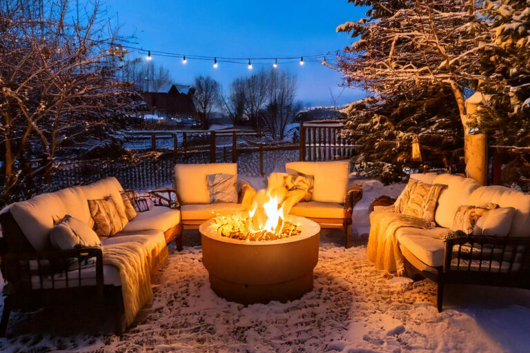 Cozy winter patio with fire pit and string lights